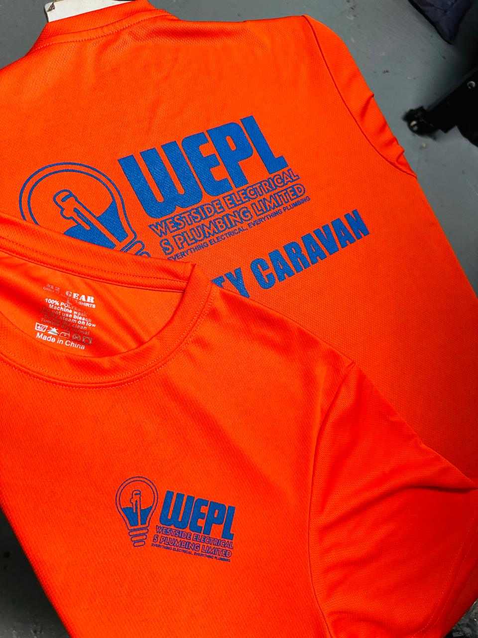 Orange shirts displaying blue WEPL emblems and business lettering.